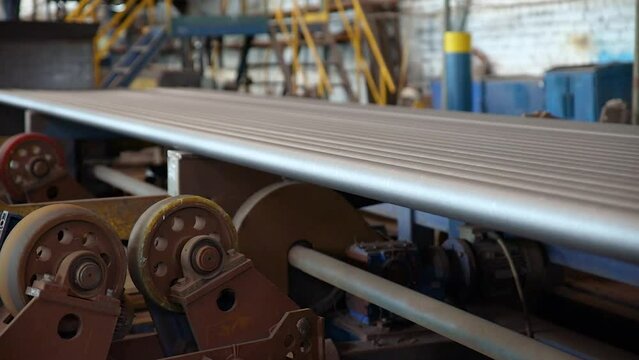 Pipe manufacturing plant. Pipe plant. Iron pipe welding. Pipe expansion. Sparks of welding. Tap. Factory. Machine tools. Production. Heavy industry.