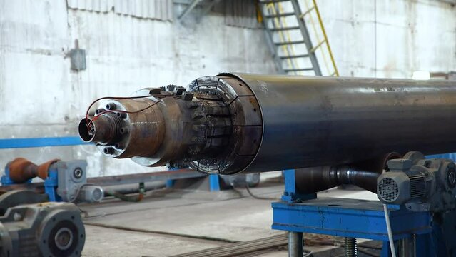 Tube manufacturing plant. Pipe metal.  Tube expansion. Tap. Factory. Production. Heavy industry.