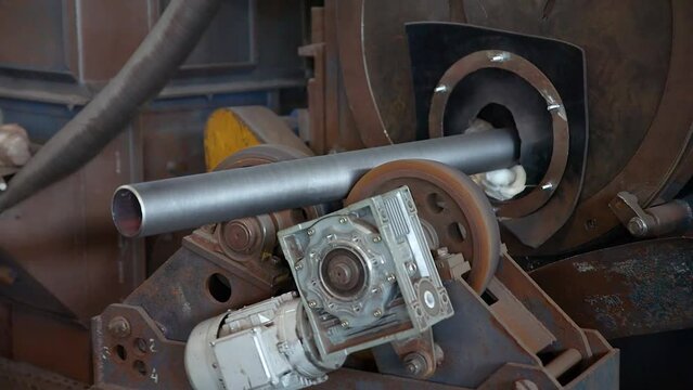 Pipe manufacturing plant. Pipe plant. Iron pipe welding. Pipe expansion. Sparks of welding. Tap. Factory. Machine tools. Production. Heavy industry.