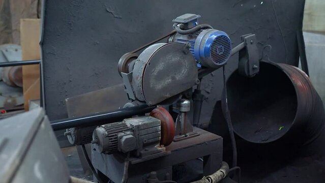 Pipe manufacturing plant. Pipe plant. Iron pipe welding. Pipe expansion. Sparks of welding. Tap. Factory. Machine tools. Production. Heavy industry.