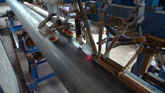 Pipe manufacturing plant. Pipe plant. Iron pipe welding. Pipe expansion. Sparks of welding. Tap. Factory. Machine tools. Production. Heavy industry.