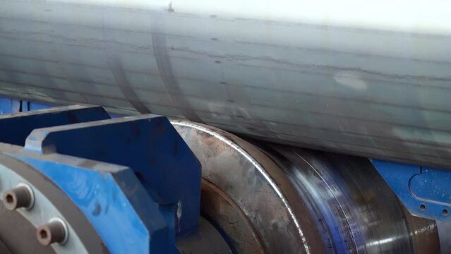 Pipe manufacturing plant. Pipe plant. Iron pipe welding. Pipe expansion. Sparks of welding. Tap. Factory. Machine tools. Production. Heavy industry.