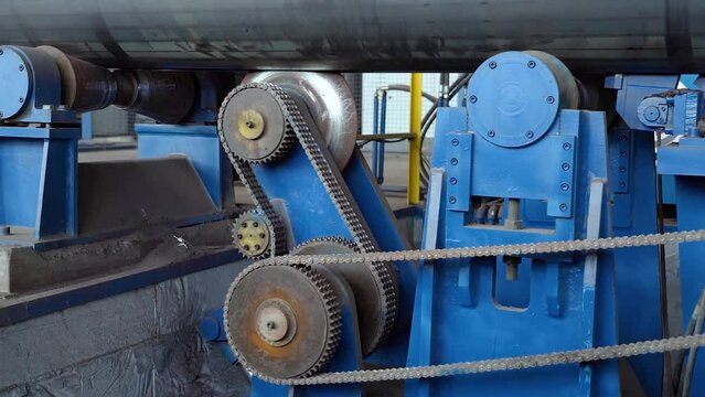 Pipe manufacturing plant. Pipe plant. Iron pipe welding. Pipe expansion. Sparks of welding. Tap. Factory. Machine tools. Production. Heavy industry.