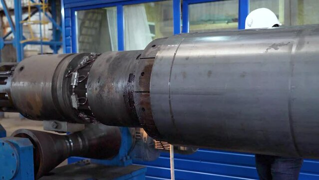 Tube manufacturing plant. Pipe metal. Tube expansion. Tap. Factory. Machine tools. Production. Heavy industry.