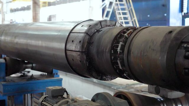 Pipe manufacturing plant. Metal tube plant. Pipe expansion. Tap. Factory. Machine tools. Production. Heavy industry.