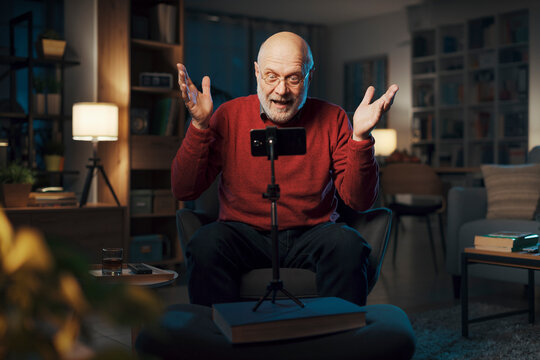 Senior man recording videos with his smartphone