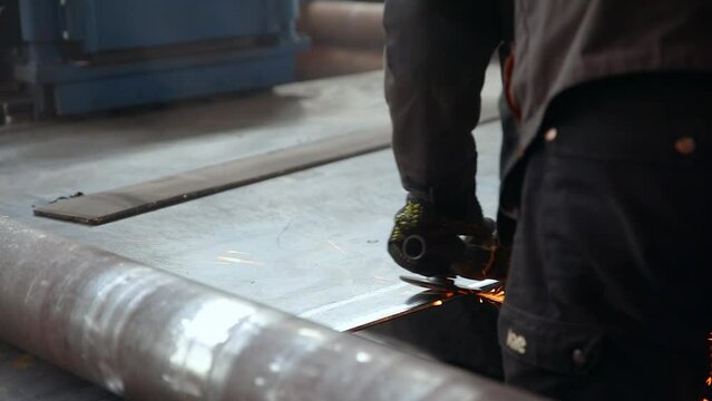 Pipe manufacturing plant. Pipe plant. Iron pipe welding. Pipe expansion. Sparks of welding. Tap. Factory. Machine tools. Production. Heavy industry.
