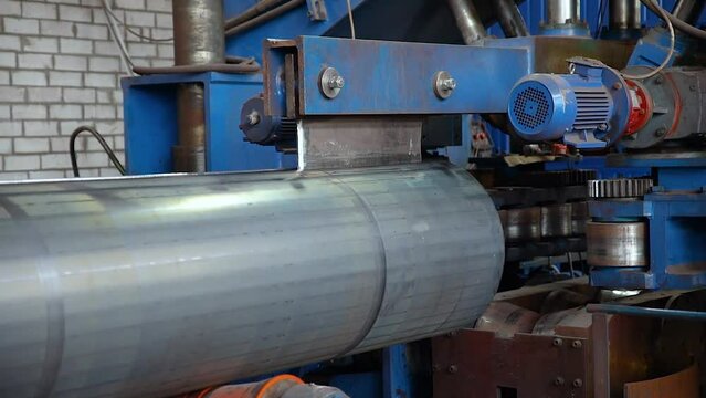Pipe manufacturing plant. Nube plant. Iron pipe welding. Pipe expansion. Tap. Factory. Machine tools. Production. Heavy industry.
