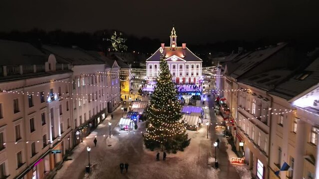  Christmas Market, aerial view. Illuminated Christmas fair in a modern city. Night time aerial footage with a drone showing the Christmas Market and Christmas tree. 