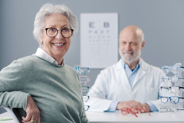 Happy senior lady choosing prescription glasses