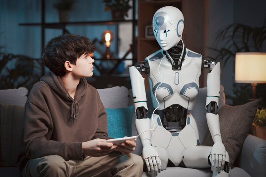 Teenager programming a humanoid AI robot