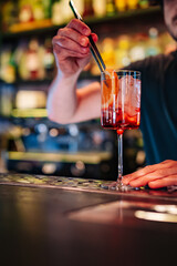man hand bartender making cocktail in glass on the bar counter