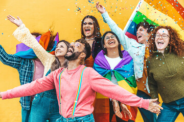 Diverse group of young people celebrating gay pride festival throwing confetti in the air - Lgbt...
