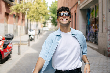 Young man with curly hair in the city