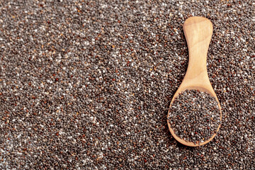 Chia seeds close-up with a wooden spoon. Chia seeds macro. Dry healthy supplement for proper nutrition.