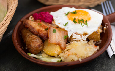 Breakfast dish - scrambled eggs with fried bacon