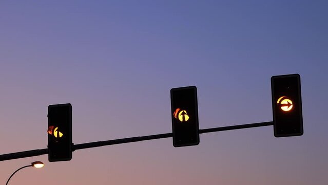 Shot of an alert yellow flashing light of a traffic light at morning.
