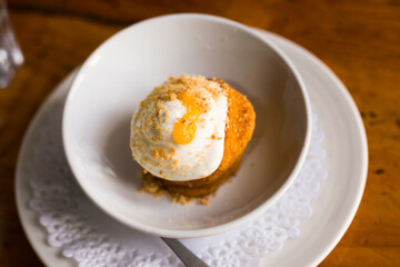 Homemade carrot cake with orange crumbs on plate close-up