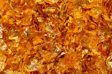 Golden texture background. Golden potal close-up glitters and shimmers. Golden holiday background.