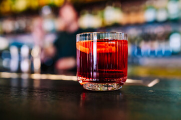 Cocktail Negroni with gin, campari martini rosso and orange. negroni cocktail in bar