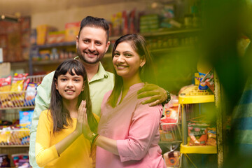 Happy Indian family at grocery shop.