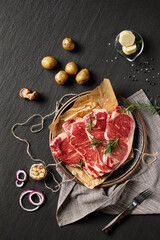 Filet mignon on tabletop on rocky background(Rosemary, garlic, butter, pepper, salt and other spices),close up