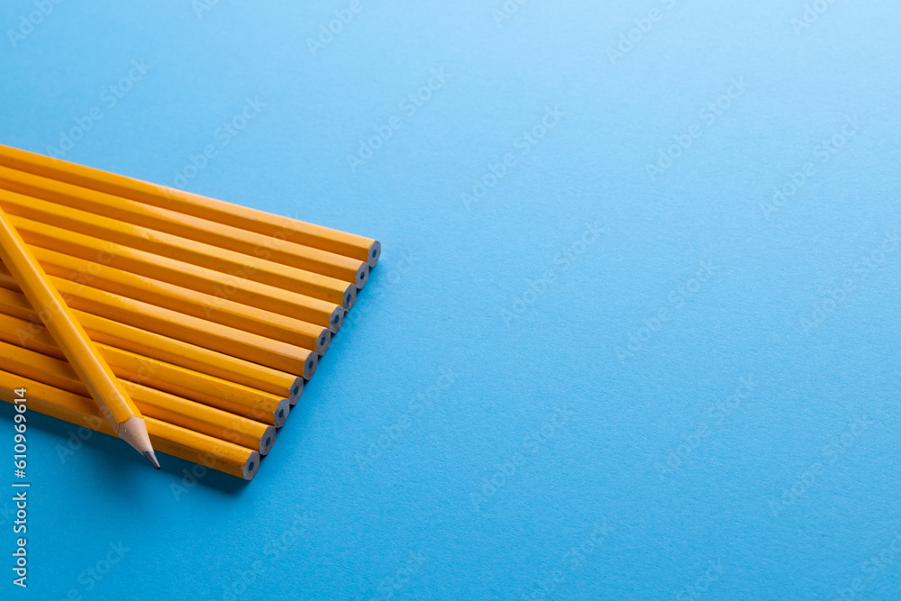 Wall mural Close up of yellow pencils and copy space on blue background