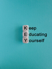 KEY, keep educating yourself symbol. Wooden cubes with words 'KEY, keep educating yourself'....