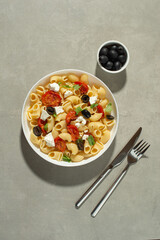 Pasta salad with dried tomatoes, cheese and olives