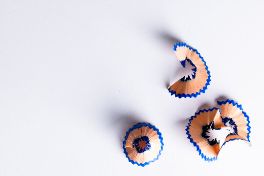 Close up of blue pencil shavings with copy space on white background