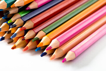 Close up of multi coloured pencils and copy space on white background