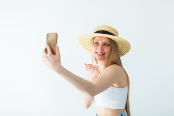 Young pretty happy blondie woman in hat doing selfie, chating