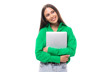 portrait of a happy slim cute brown-eyed brunette woman dressed in a green shirt working using a laptop. online work concept