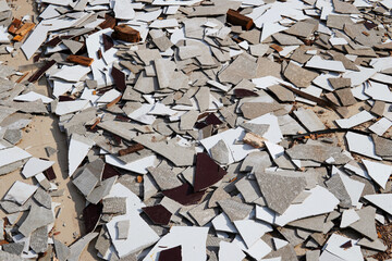 Gypsum scrap and tile debris on the floor
