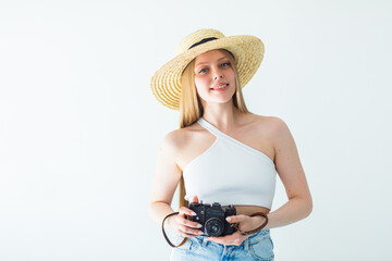 Happy blondie girl in hat with camera on white background