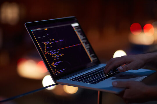 Hacker, programming and laptop with hands of person for ransomware, cyber security and phishing. Coding, technology and crime with closeup of programmer for fraud, network system and data at night - Powered by Adobe