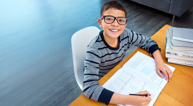 Happy boy, student and portrait with book for studying, learning or education in math at home on mockup. Smart little kid or child and smile for mathematics, textbook or problem solving on study desk