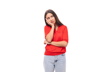 young european woman with black hair dressed in a red t-shirt on a white background with copy space