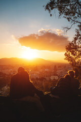 romantic lovely couples watch beautiful sunset in Malaga, Spain