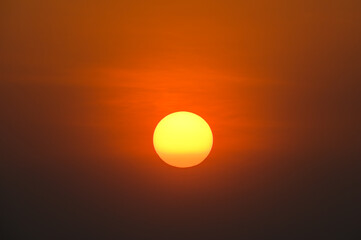 big orange sun on sunset background