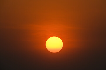 big orange sun on sunset background