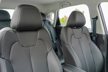 Car Inside. Interior of prestige modern car. Comfortable leather seats. Black perforarated leather cockpit.