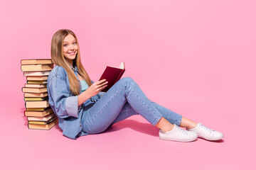 Photo of charming smart lovely girl wear trendy clothes hold detective story novel sit floor empty...