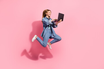 Fototapeta na wymiar Photo of cheerful charming stylish girl flying air typing writing sms message go hurry store center isolated on pink color background