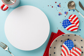 Prepare for Independence Day USA with artistic table display. Top view of plate, cutlery, cup, napkin, hearts with American flag, confetti on pastel blue backdrop with circle available for text or ad
