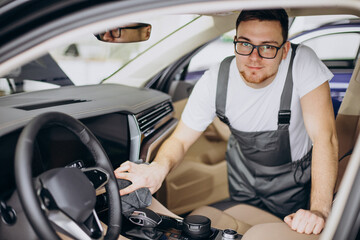 Man polishing car inside at car service