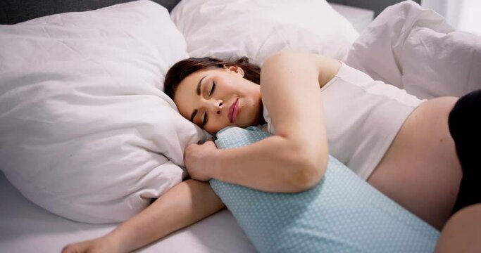 Pregnant Woman Sleeping On Bed