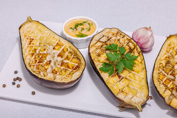 Grilled eggplants with olive oil, garlic and greens. Traditional food for picnic or barbecue