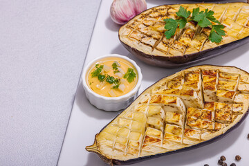 Grilled eggplants with olive oil, garlic and greens. Traditional food for picnic or barbecue