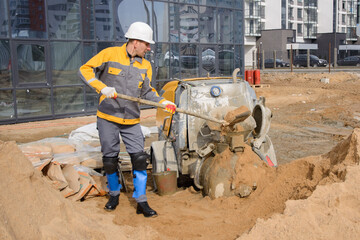 construction worker with shovel and bucket on construction site  of new building